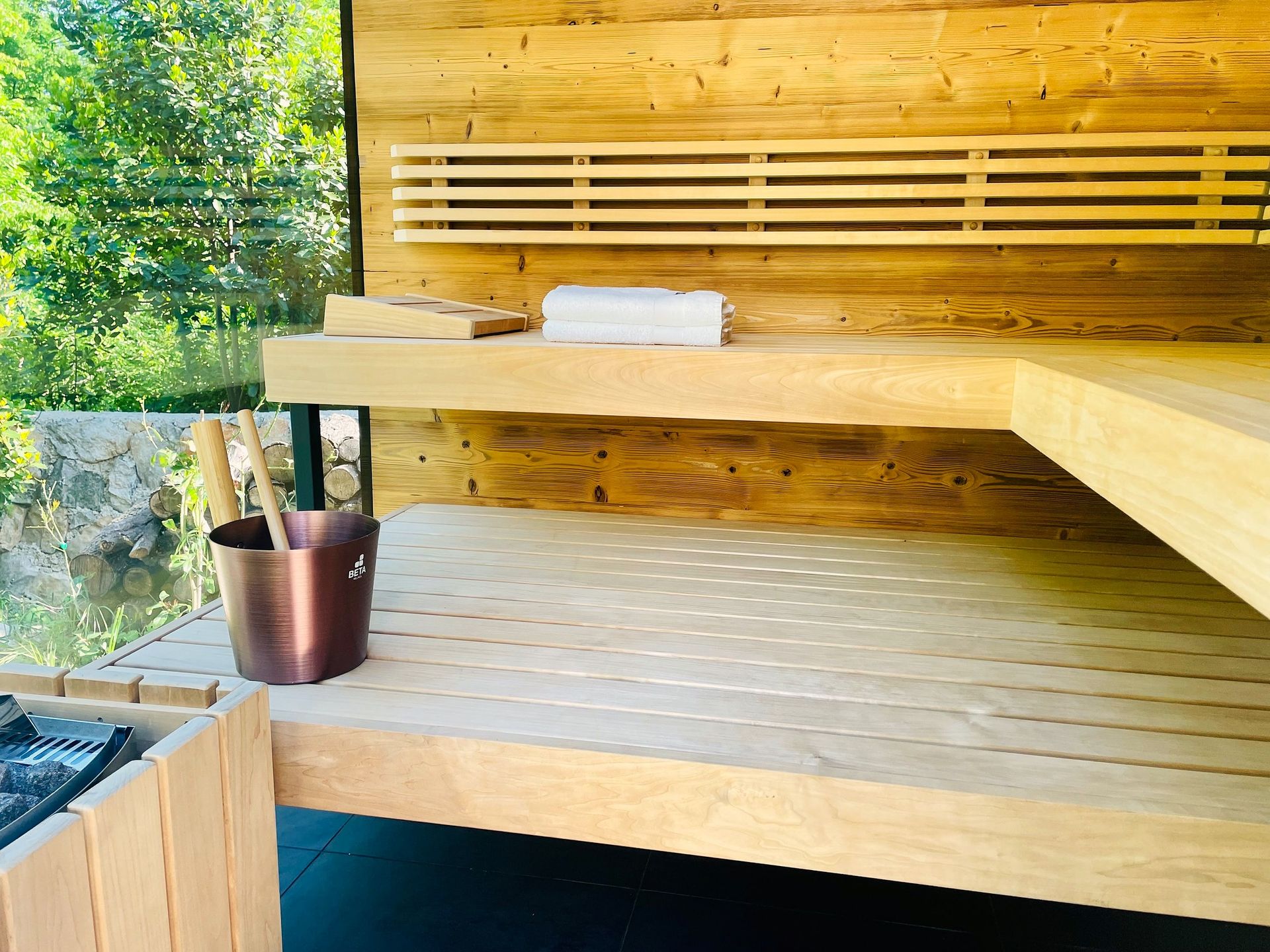 warm cedar sauna interior with garden view