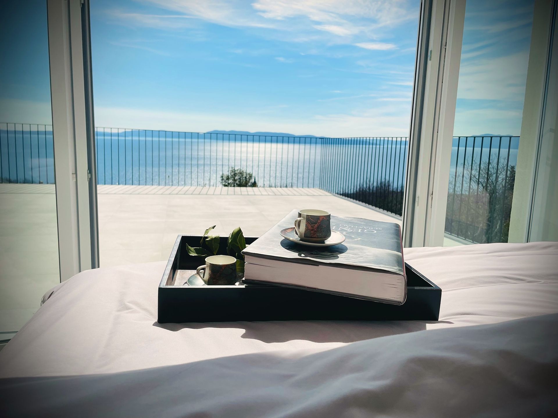 breakfast tray on bed facing the sea