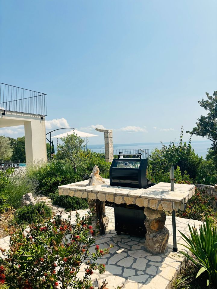outdoor barbecue station with sea horizon beyond