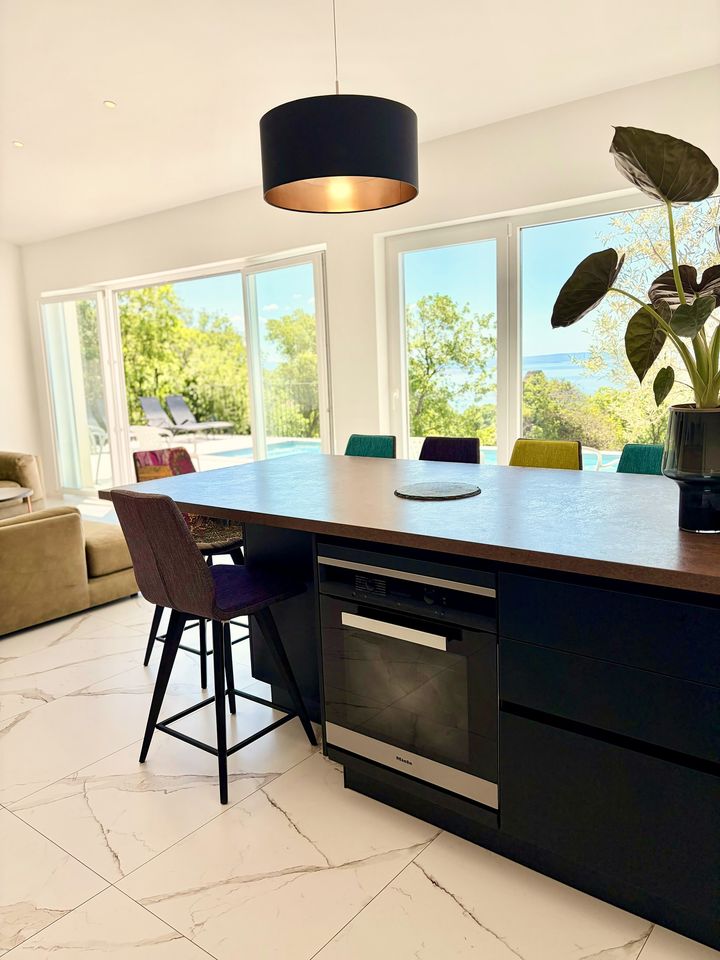 designer island kitchen with sea and pool view