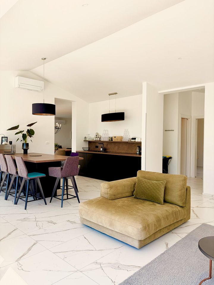 airy open living, olive armchair, marble floor