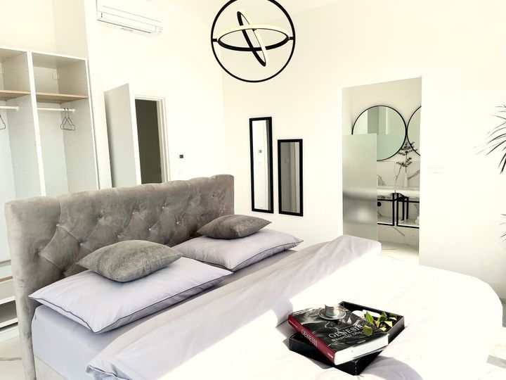 tufted headboard suite with twin-mirror ensuite