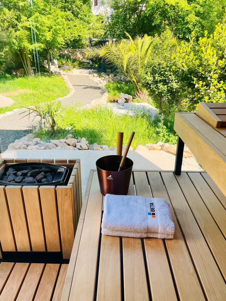 outdoor cedar sauna deck opening to garden